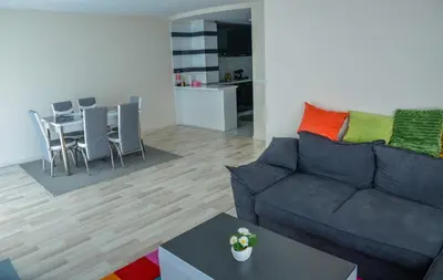 a living room with a couch and a table at Къща за гости Хаджиеви in Ognyanovo