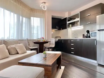a living room with a couch and a kitchen at Sunny & Cozy Apartment for 4 Guests & Free Parking in Plovdiv
