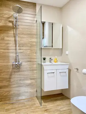 a bathroom with a white sink and a shower at Sunny & Cozy Apartment for 4 Guests & Free Parking in Plovdiv