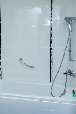 a bath tub with a shower with a hose at private apartment in a five-star hotel in Bansko in Bansko