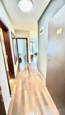 an empty room with a hallway with a door at ALTITUDE MOUNTAIN APARTMENTS ASPEN at GONDOLA BANSKO in Bansko