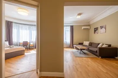 a living room with a couch and a bed in a room at Stunning Luxury 3 Bedroom Apt in the Heart of Town in Sofia