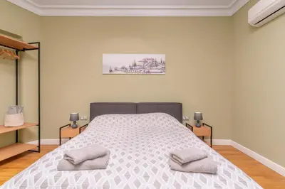 a bedroom with a bed with two pillows on it at Stunning Luxury 3 Bedroom Apt in the Heart of Town in Sofia