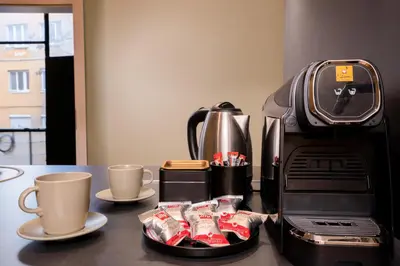 a coffeemaker and coffee cups on a table at Stunning Luxury 3 Bedroom Apt in the Heart of Town in Sofia