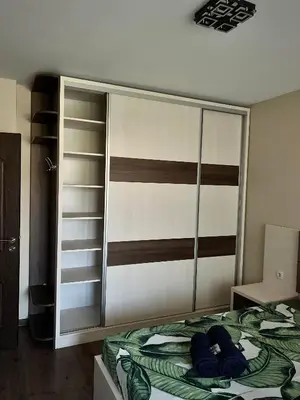 a bedroom with a bed with blue pillows on it at Ultra Lux Apartment Free Underground Secure Parking in Pazardzhik