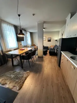 a kitchen and living room with a table and a dining room at Art apartment Pamporovo Grand Monastery in Pamporovo
