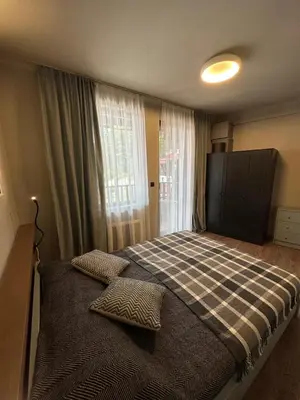 a bedroom with a bed with two pillows on it at Art apartment Pamporovo Grand Monastery in Pamporovo