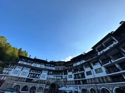 a large white building with a lot of windows at Art apartment Pamporovo Grand Monastery in Pamporovo