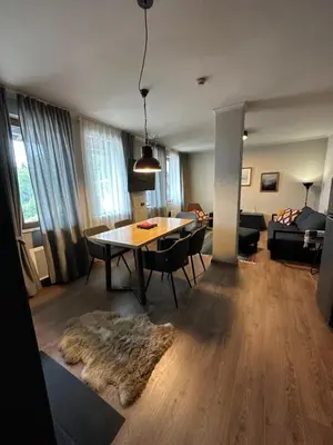 a living room with a table and chairs and a couch at Art apartment Pamporovo Grand Monastery in Pamporovo