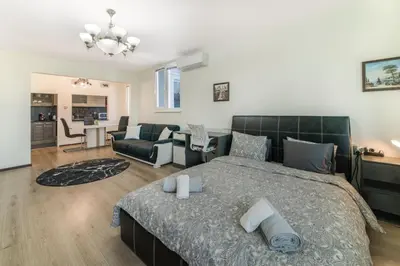 a bedroom with a bed and a living room at Sunny Sofia Studio #1 in Sofia