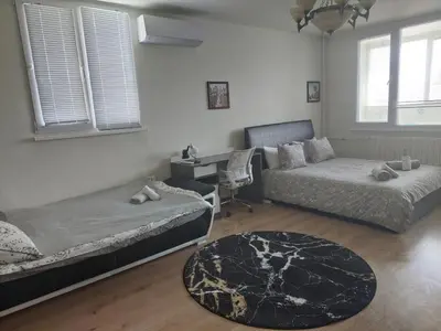 a bedroom with two beds and a desk and a couch at Sunny Sofia Studio #1 in Sofia
