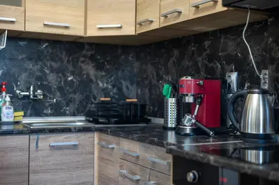 a kitchen with wooden cabinets and a counter top at Sunny Sofia Studio #1 in Sofia