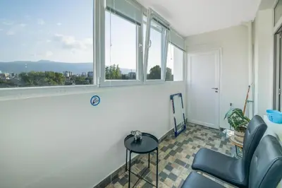 a room with a chair and a window at Sunny Sofia Studio #1 in Sofia
