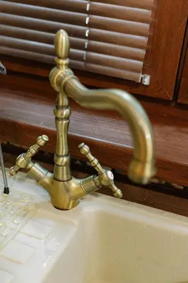 a brass sink faucet on a white sink at Top Center Relax, NDK & Vitoshka str, FREE Secured parking in Sofia