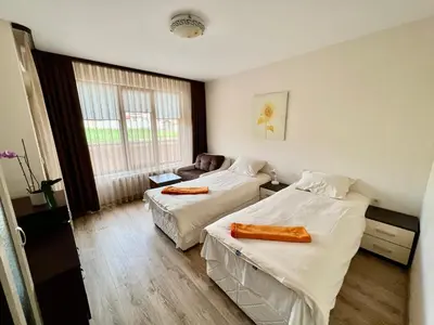 a hotel room with two beds and a couch at Hani Guest House in Garmen