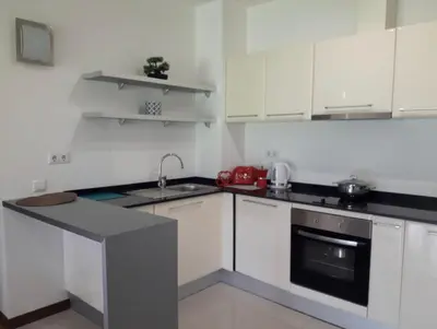 a small kitchen with white cabinets and a sink at Apartament by Zenit in Terra Complex C30 in Razlog