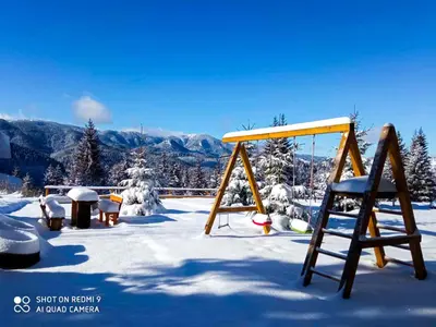 a swing set in the snow with mountains in the background at Panorama View-Stoykite in Stoykite