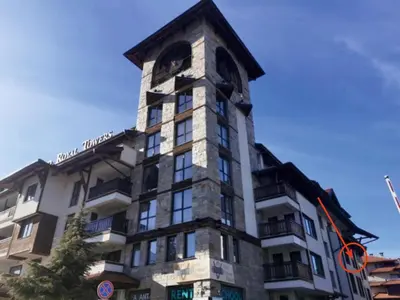 a tall building with a clock tower on it at Ski Lift Studio 531 in Bansko