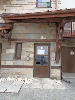a building with a door with a person standing in front at Ski Lift Studio 531 in Bansko
