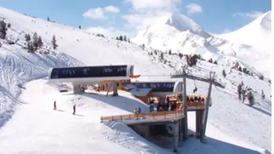 a group of people on a ski lift on a snow covered mountain at Ski Lift Studio 531 in Bansko