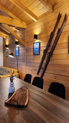 a room with a table with skis on the wall at HillVill in Govedartsi