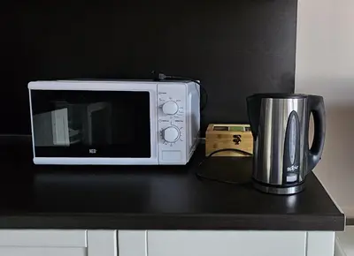 a microwave and a coffee pot on a counter at Four Seasons Apartment Bansko in Bansko