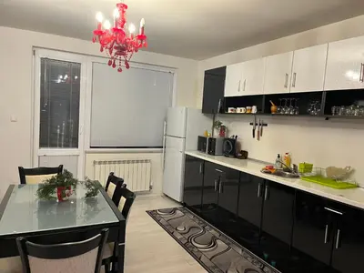 a kitchen with a dining table and a refrigerator at The best choice in Sofia in Sofia