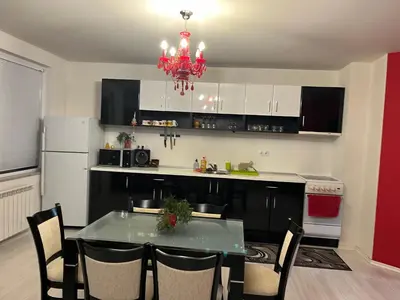 a kitchen with a dining room table and a chandelier at The best choice in Sofia in Sofia