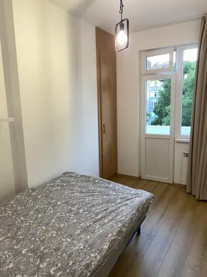 a bedroom with a bed and a window at Trendy and stylish in city centre for business and leisure in Sofia
