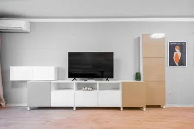 a living room with a television on a white entertainment center at Urban Elegance at Its Finest Stylish 1-BD Flat by Flat Mаnager in Sofia