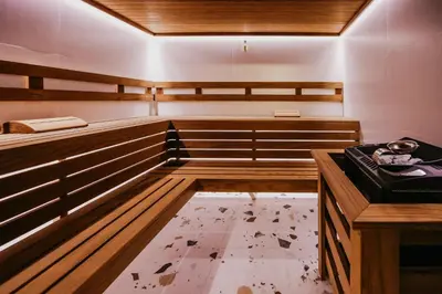 a sauna with wooden cabinets and a floor at Hotel Green Park Service Perfected in Garmen