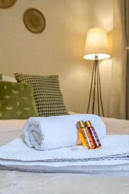 a towel with a tube of toothpaste and a book on a bed at #Maison\u32b6 - A Vibrant, Urban Stay in Sofia