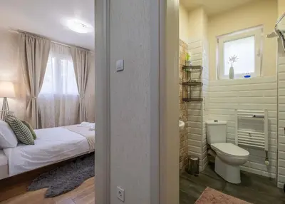 a bedroom with a bed and a toilet and a window at #Maison\u32b6 - A Vibrant, Urban Stay in Sofia