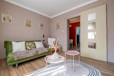 a living room with a green couch and two tables at #Maison\u32b6 - A Vibrant, Urban Stay in Sofia