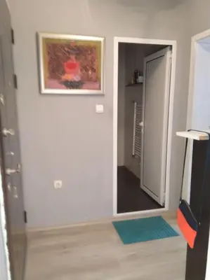 a room with a hallway with a painting on the wall at Апартамент до парк и метро in Sofia