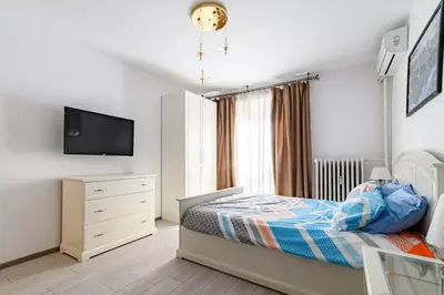 a bedroom with a bed and a tv on a wall at 10 Seconds Away from the Main street, Free Secured Parking in Sofia