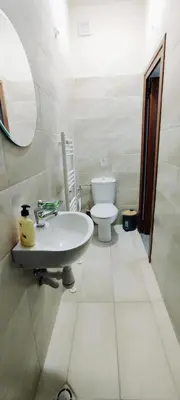 a bathroom with a sink and a toilet at Mountain Pearls Home 8 in Vodata