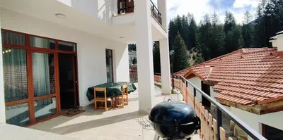 a balcony of a house with a table at Mountain Pearls Home 8 in Vodata