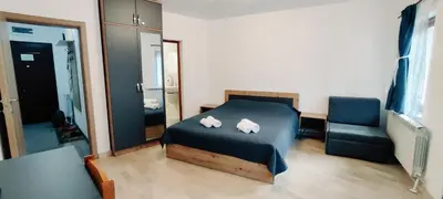 a bedroom with a bed and a mirror and a chair at Mountain Pearls Home 8 in Vodata