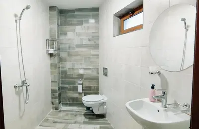 a bathroom with a toilet and a sink and a mirror at Mountain Pearls Home 8 in Vodata
