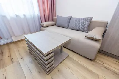 a living room with a couch and a table at Family Hotel Ambrozia in Sandanski