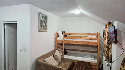 a small room with a bunk bed and a couch at The Castle Mansarde on the slope 7 - Pamporovo in Pamporovo
