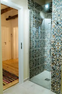 a shower with a glass door in a room at Къща за гости РАДЕЯ in Govedartsi