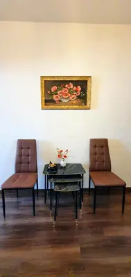 two chairs and a table and a painting on the wall at АПАРТАМЕНТ ЮЛИЯ ДЕЛУКС I in Velingrad