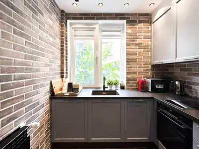 a kitchen with a brick wall and a sink at 2BR by NDK - AC - Desk - Lux Interior - Balcony in Sofia
