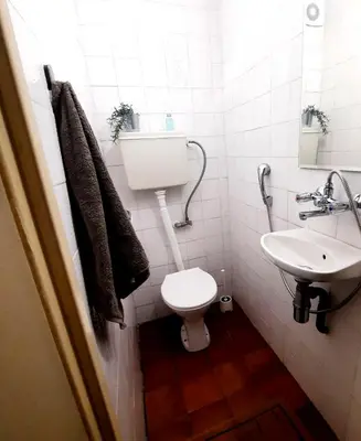 a small bathroom with a toilet and a sink at Spacious 3 bedroom apartment, close to metro station in Sofia