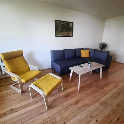 a living room with a couch and chairs and a table at Spacious 3 bedroom apartment, close to metro station in Sofia
