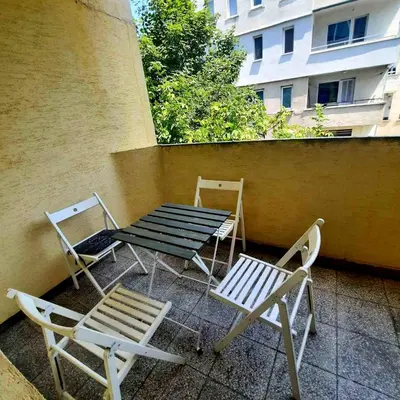 two chairs and a table and chairs on a patio at Spacious 3 bedroom apartment, close to metro station in Sofia