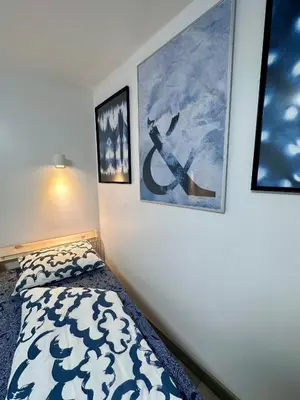 a bedroom with two pictures on the wall and a bed at The rainbow 8 in Sofia