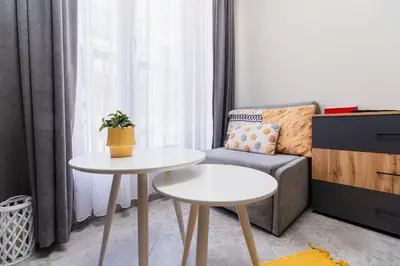 a living room with a couch and a table at City Center Studio Apartments in Plovdiv